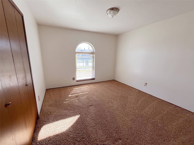 unfurnished bedroom with carpet floors and a closet