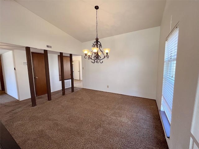 carpeted empty room featuring an inviting chandelier and high vaulted ceiling