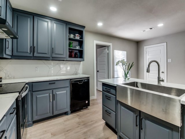 kitchen featuring sink, light hardwood / wood-style flooring, dishwasher, stainless steel range with electric cooktop, and wall chimney exhaust hood