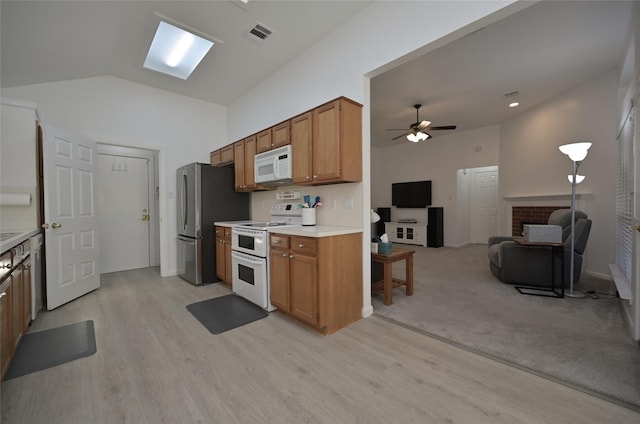 kitchen with ceiling fan, white appliances, lofted ceiling, and light hardwood / wood-style flooring