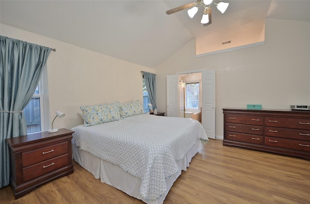 bedroom with lofted ceiling, ceiling fan, and light hardwood / wood-style flooring