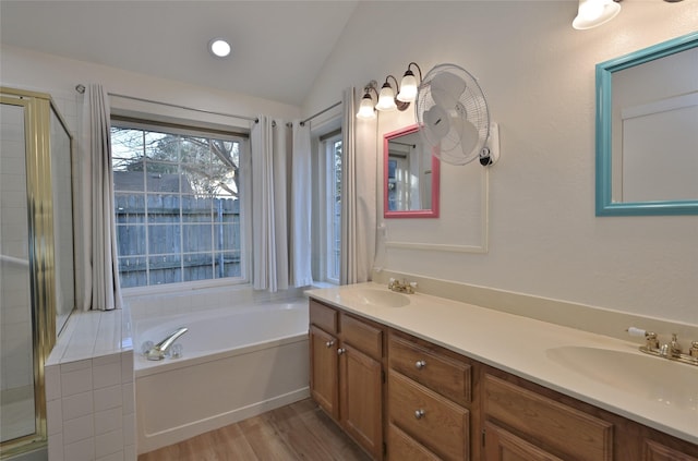 bathroom with vanity, lofted ceiling, hardwood / wood-style floors, and plus walk in shower