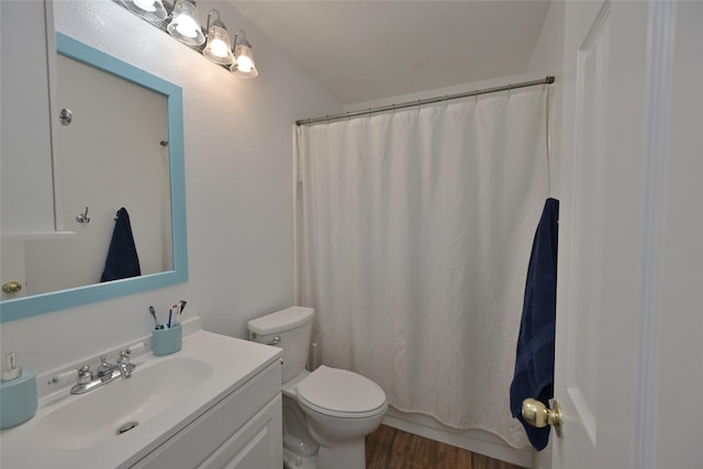 bathroom with a shower with shower curtain, vanity, toilet, and hardwood / wood-style floors