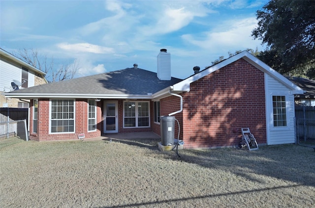 rear view of house featuring a lawn