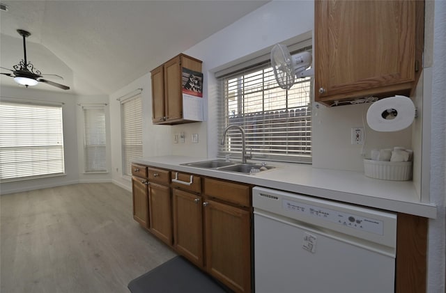 kitchen with sink, ceiling fan, dishwasher, vaulted ceiling, and light wood-type flooring