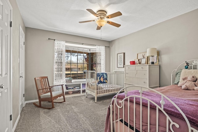 bedroom featuring a textured ceiling, ceiling fan, and carpet