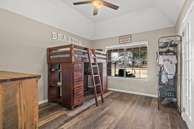 bedroom featuring ceiling fan, a tray ceiling, and dark hardwood / wood-style flooring