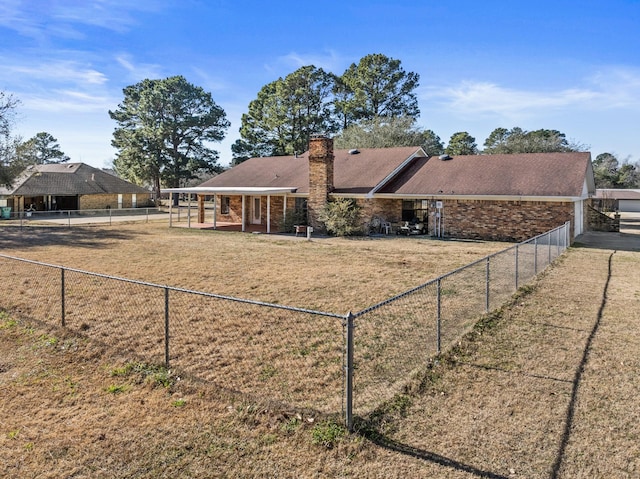 rear view of property featuring a yard