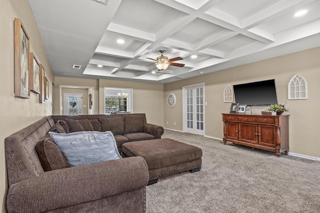 living room featuring beamed ceiling, ceiling fan with notable chandelier, coffered ceiling, and light carpet