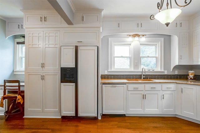 kitchen featuring arched walkways, white cabinetry, white dishwasher, a sink, and wood finished floors