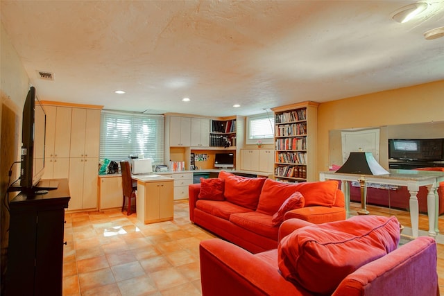 living area with visible vents, a textured ceiling, and recessed lighting