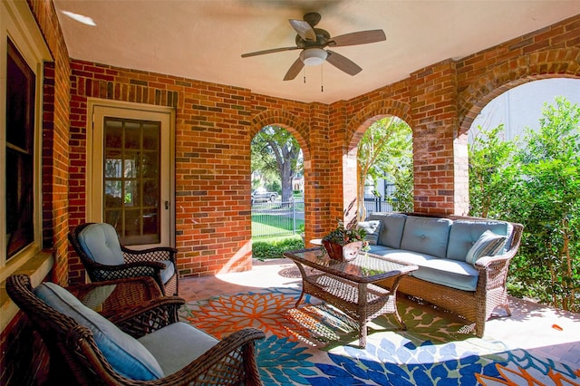 view of patio featuring outdoor lounge area, fence, and ceiling fan