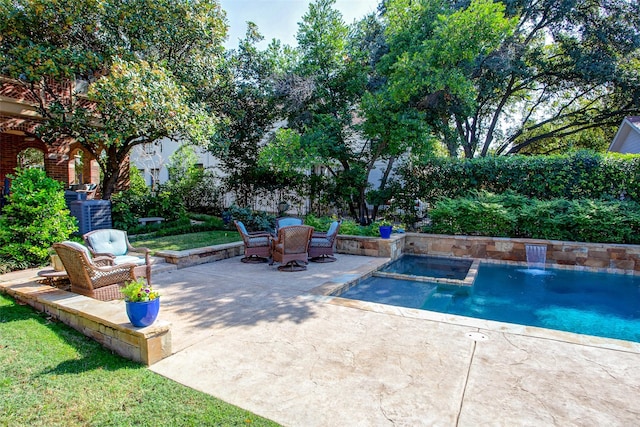 view of swimming pool with a patio and a pool with connected hot tub