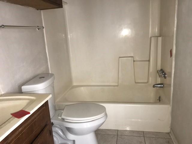 full bathroom featuring vanity, tile patterned flooring, bathtub / shower combination, and toilet