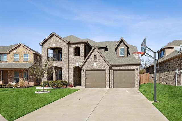 view of front facade with a balcony, a garage, and a front lawn