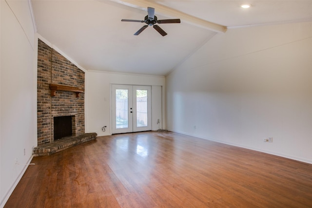 unfurnished living room with french doors, a fireplace, hardwood / wood-style floors, and vaulted ceiling with beams