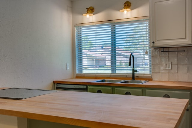 kitchen with white cabinetry, a healthy amount of sunlight, butcher block counters, and sink