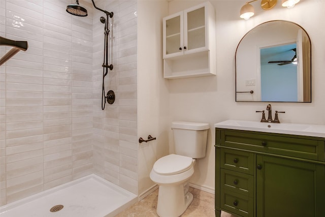 bathroom featuring vanity, tiled shower, and toilet