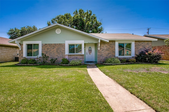 ranch-style home with central AC unit and a front yard