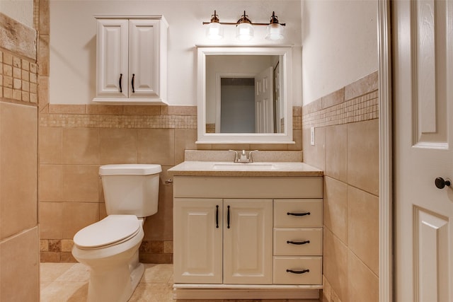 bathroom with tile patterned flooring, vanity, tile walls, and toilet