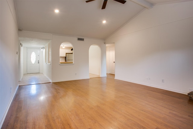 unfurnished living room with lofted ceiling with beams, ceiling fan, ornamental molding, and light wood-type flooring