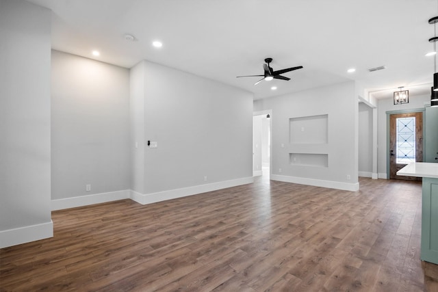 unfurnished living room featuring hardwood / wood-style flooring and ceiling fan