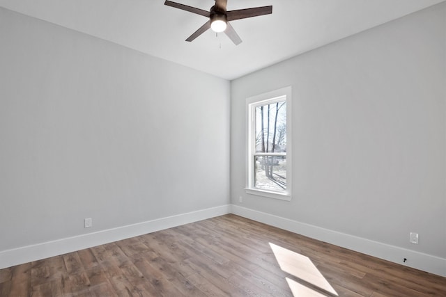 spare room with hardwood / wood-style floors and ceiling fan