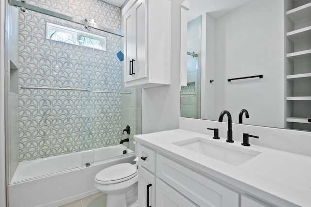 full bathroom featuring bath / shower combo with glass door, vanity, tile patterned floors, and toilet