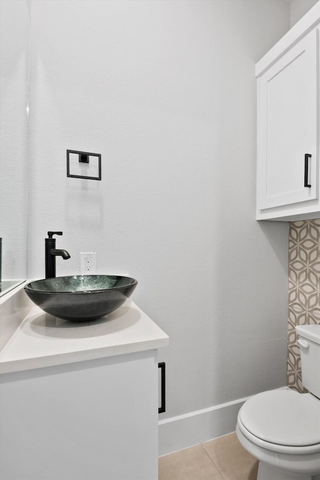 bathroom featuring tile patterned flooring, vanity, and toilet