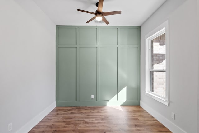 unfurnished bedroom with ceiling fan and light wood-type flooring