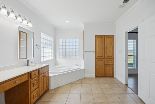 bathroom with a relaxing tiled tub, ornamental molding, tile patterned floors, and vanity