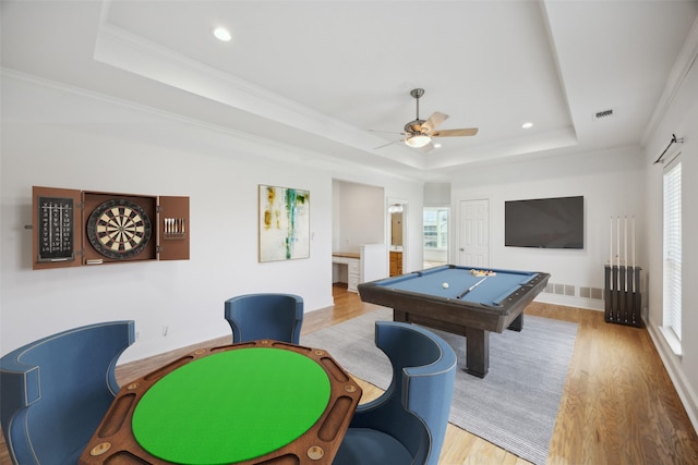 playroom featuring ornamental molding, pool table, ceiling fan, a raised ceiling, and light wood-type flooring