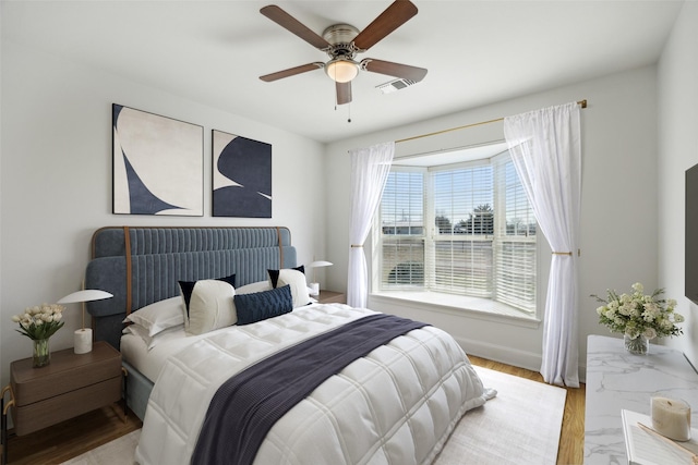 bedroom with light hardwood / wood-style flooring and ceiling fan