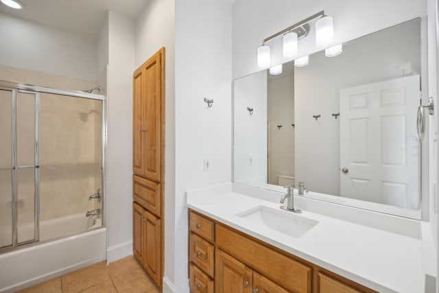 full bathroom with enclosed tub / shower combo, vanity, toilet, and tile patterned flooring