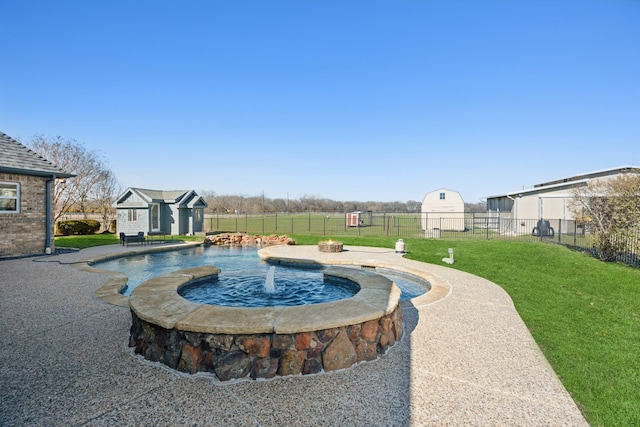 view of swimming pool featuring a patio, pool water feature, a yard, and an outdoor structure