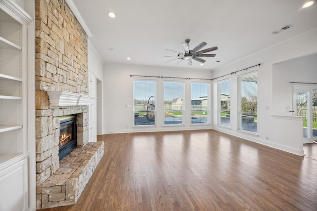 unfurnished living room with crown molding, hardwood / wood-style floors, ceiling fan, and a fireplace