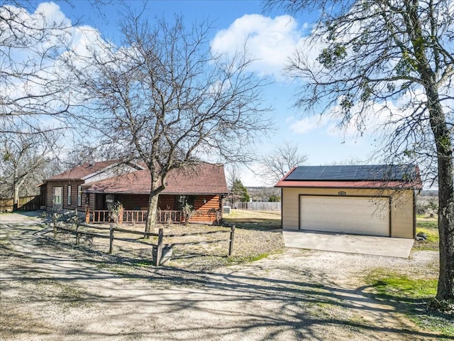 view of front of property featuring a garage and solar panels