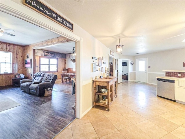 interior space featuring wooden walls and ceiling fan