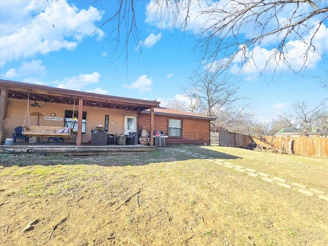 rear view of property with a yard and a patio