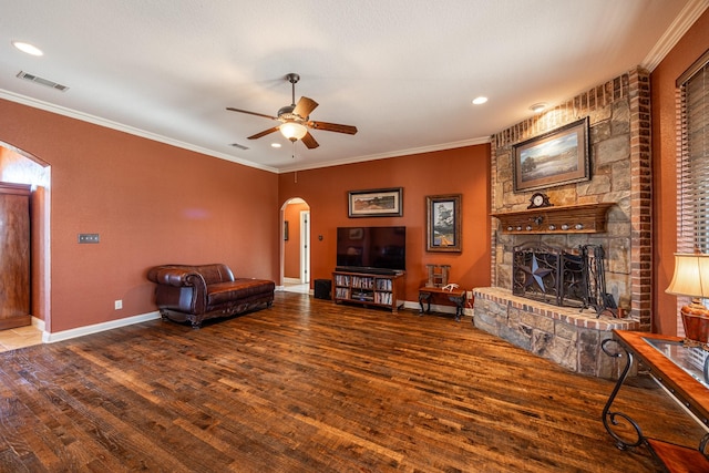 166 Cactus Dr, Decatur, TX 76234 - living area with ceiling fan, arched walkways, a stone fireplace, wood finished floors, and visible vents