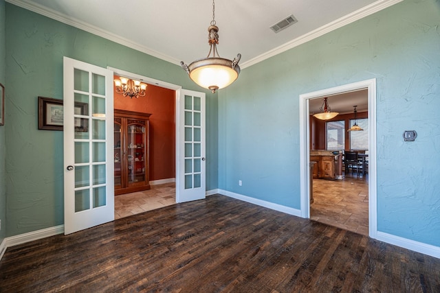 166 Cactus Dr, Decatur, TX 76234 - unfurnished dining area with french doors, visible vents, crown molding, wood finished floors, and a chandelier