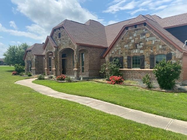 166 Cactus Dr, Decatur, TX 76234 - tudor house with brick siding, stone siding, and a front yard