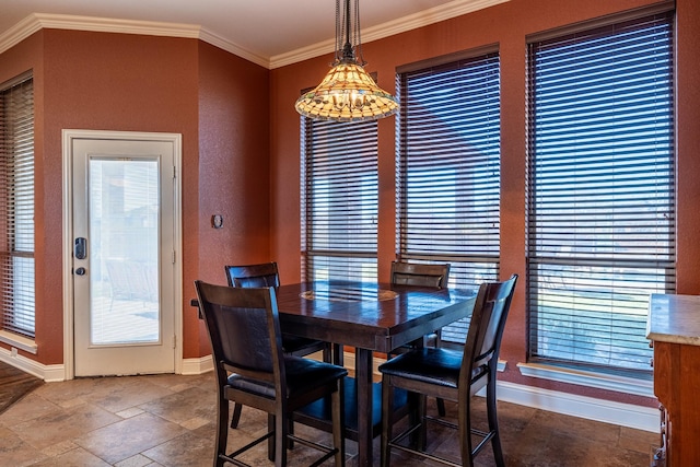 166 Cactus Dr, Decatur, TX 76234 - dining area with baseboards, stone tile floors, a textured wall, and ornamental molding