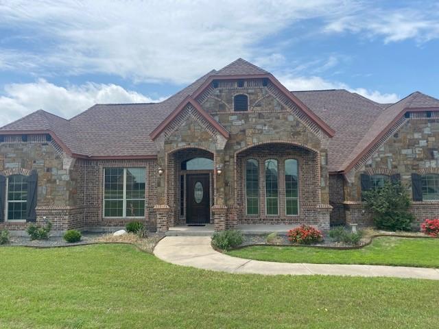 166 Cactus Dr, Decatur, TX 76234 - french country style house featuring stone siding, a front lawn, and brick siding