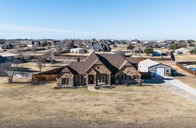 166 Cactus Dr, Decatur, TX 76234 - view of front of home with a residential view, fence, stone siding, and concrete driveway