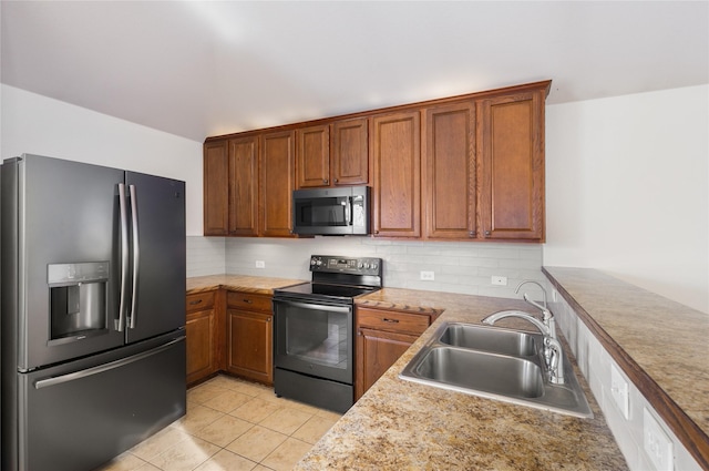 kitchen featuring tasteful backsplash, stainless steel appliances, sink, and light tile patterned floors