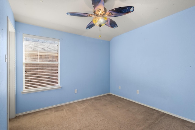 empty room featuring ceiling fan and carpet