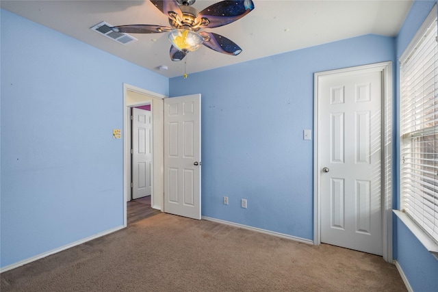 unfurnished bedroom featuring ceiling fan and carpet