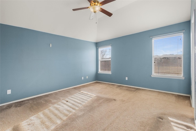 empty room with lofted ceiling, carpet floors, and ceiling fan