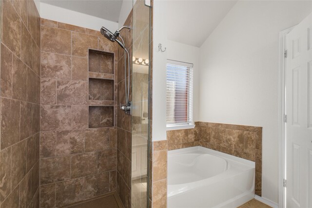 bathroom featuring lofted ceiling and shower with separate bathtub